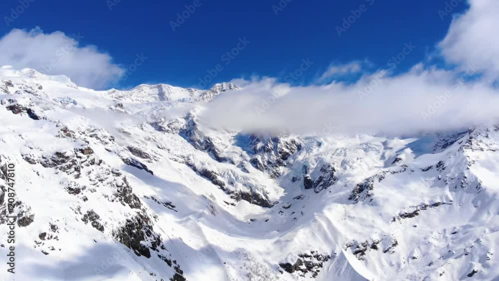 Winter mountains aerial shot. Aerial View Of Free Ride Resort In Monte Rosa Italy. Free Ride Slopes. Big mountains adventure.back country ski area. Big Mountains and glacier. High peaks landscape Winter mountains aerial shot. Aerial View Of Free Ride Resort In Monte Rosa Italy. Free Ride Slopes. Big mountains adventure.back country ski area. Big Mountains and glacier. High peaks landscape