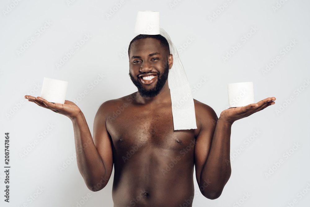 Black man holds roll of toilet paper on head Stock Photo | Adobe Stock