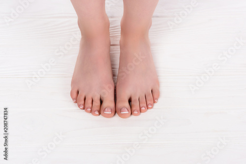 Fototapeta Naklejka Na Ścianę i Meble -  cropped shot of barefoot woman on pedicure procedure in beauty salon