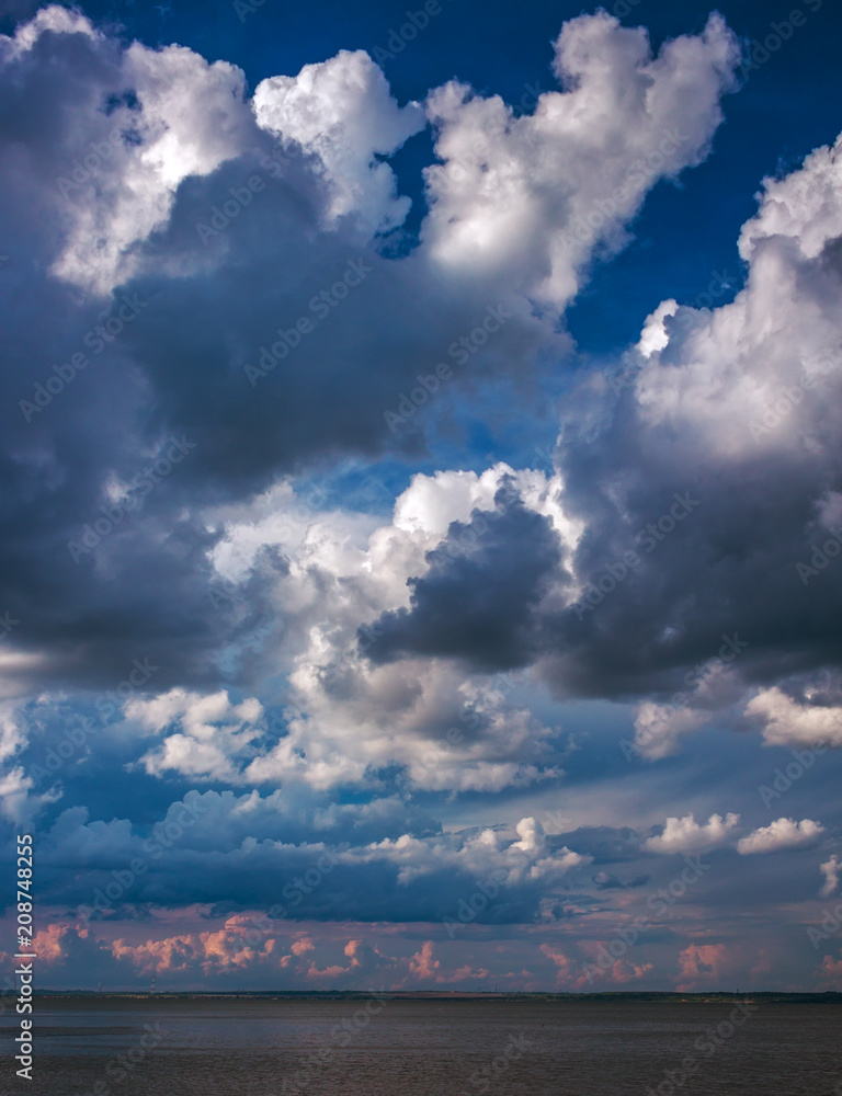 island in the ocean, against a background of beautiful clouds at sunset. island in the ocean, against a background of beautiful clouds at sunset.