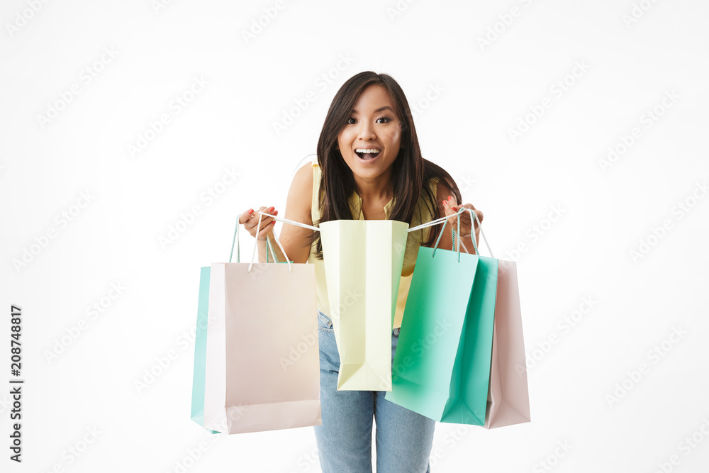 Excited young asian woman with shopping bags. Excited young asian woman with shopping bags.