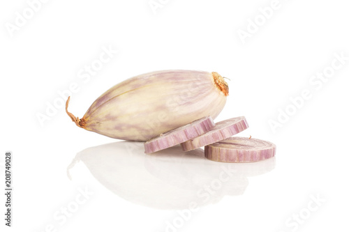 One peeled shallot and three ring slices isolated on white background. photo