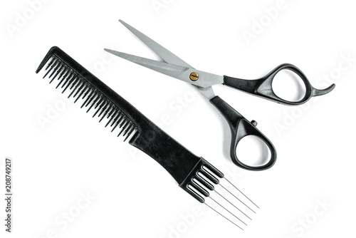 Black hair scissors and comb isolated on white background.