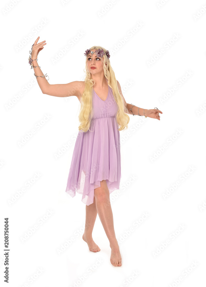 full length portrait of pretty blonde girl wearing purple fairy dress. standing pose, isolated on white studio background. full length portrait of pretty blonde girl wearing purple fairy dress. standing pose, isolated on white studio background.