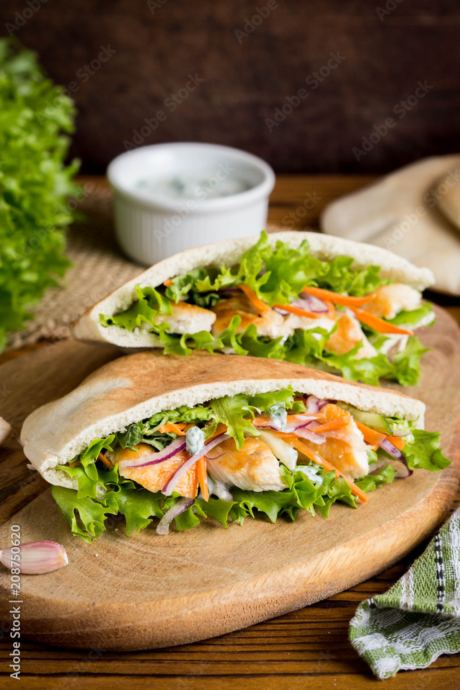 Pita with chicken, vegetables and sauce, delicious lunch, fast food, stuffed roll