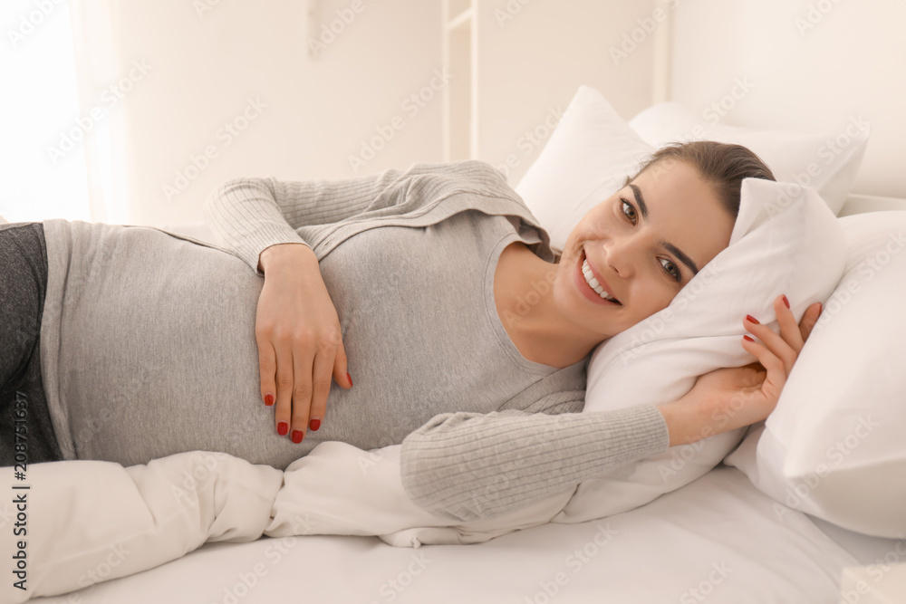 Morning of beautiful pregnant woman lying on bed Morning of beautiful pregnant woman lying on bed