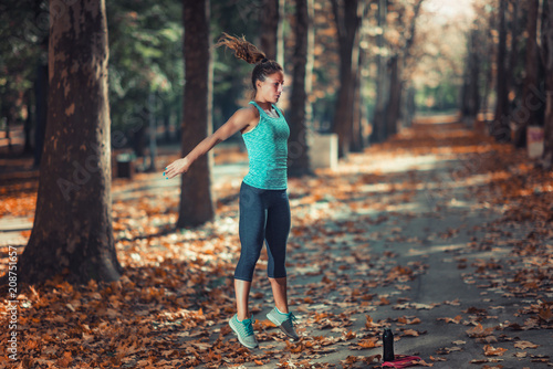 Woman Exercising Outdoors in The Fall