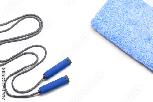Jump rope and clean towel on white background
