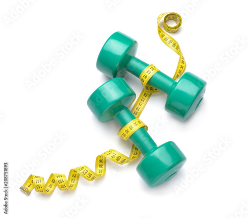 Dumbbells and measuring tape on white background © Pixel-Shot
