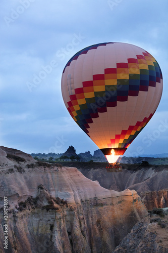 A balloon is flying over the valley in Cappadocia