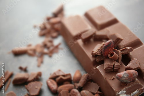 Delicious chocolate, cacao beans and shavings, closeup