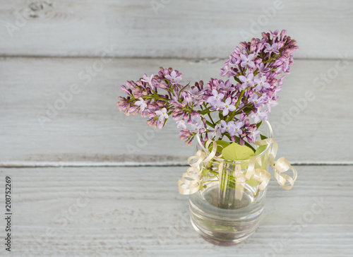 Wallpaper Mural lilac in a transparent vase on a wooden background Torontodigital.ca