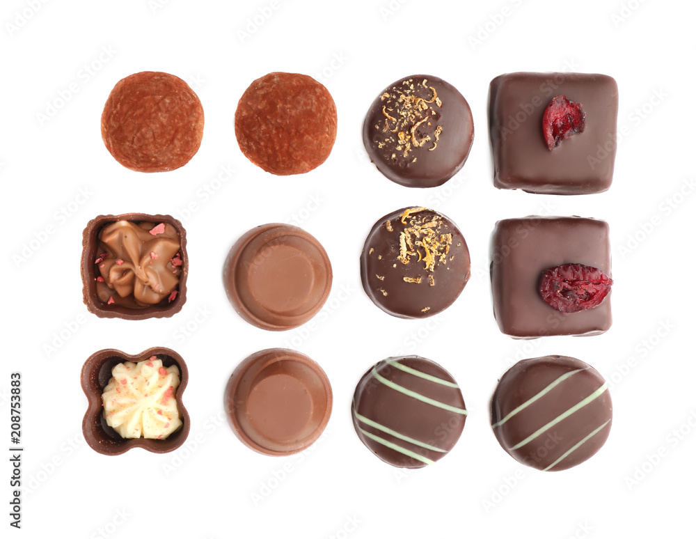 Tasty chocolate candies on white background, flat lay Tasty chocolate candies on white background, flat lay