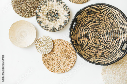 Decorative straw plates on white wall.