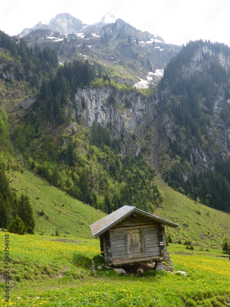 Wooden mountain hut seen against backdrop of mountains at Werzisboden, Bernese Oberland, Switzerland