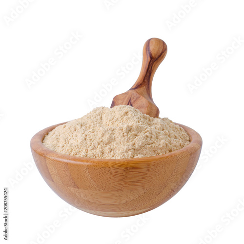 coconut flour in a bowl with wooden scoop isolated on white