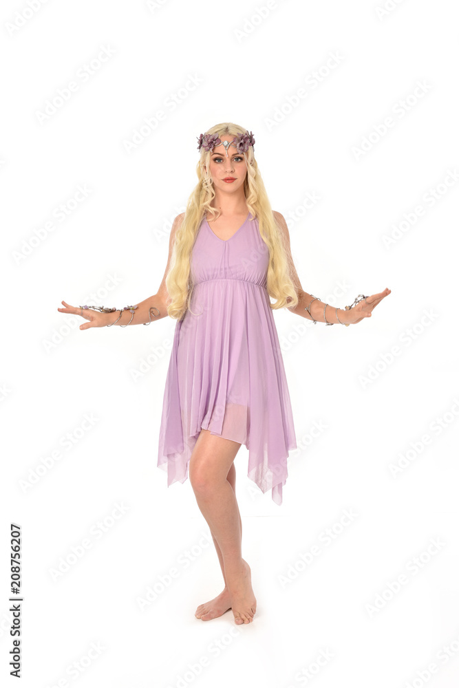 full length portrait of pretty blonde girl wearing purple fairy dress. standing pose, isolated on white studio background. full length portrait of pretty blonde girl wearing purple fairy dress. standing pose, isolated on white studio background.