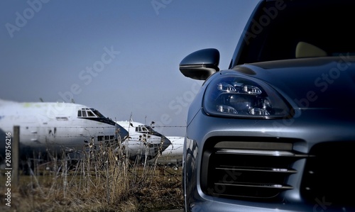 Transportation service. White aircrafts behind the passenger vehicle
