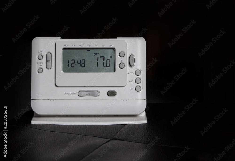 Fototapeta premium Home radio-controlled thermostat isolated on black.