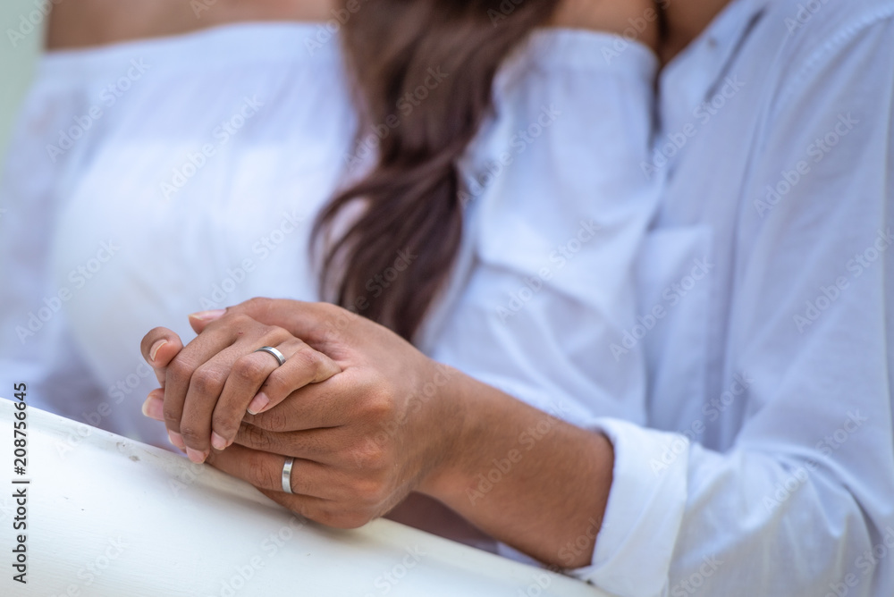 Happy Asian young couple holding hand , looking and laughing each other with happiness together, close up, romantic couple spending time concept.