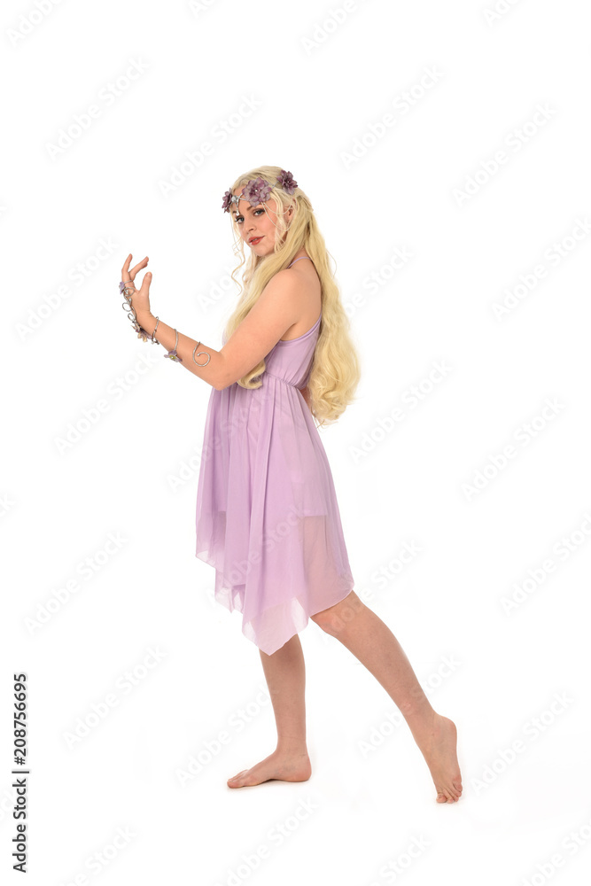 full length portrait of pretty blonde girl wearing purple fairy dress. standing pose, isolated on white studio background. full length portrait of pretty blonde girl wearing purple fairy dress. standing pose, isolated on white studio background.