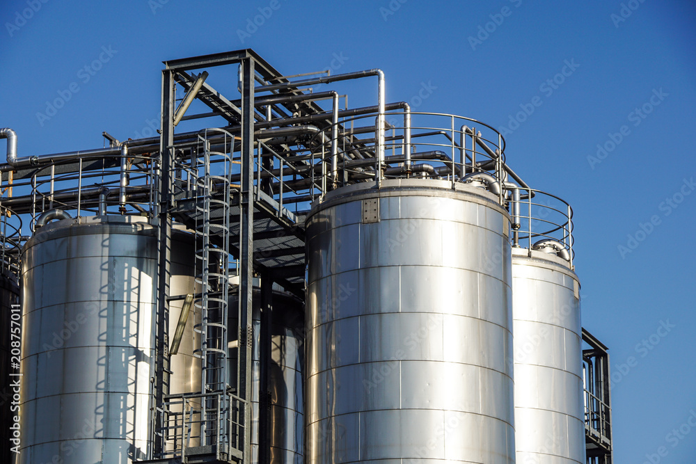 Silver wine Silos with blue sky in background Silver wine Silos with blue sky in background