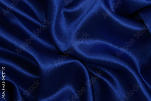 Smooth elegant blue silk or satin luxury cloth texture as abstract background. Luxurious background design