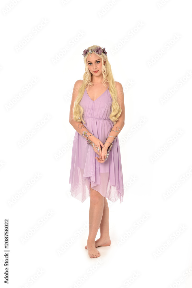 full length portrait of pretty blonde girl wearing purple fairy dress. standing pose, isolated on white studio background. full length portrait of pretty blonde girl wearing purple fairy dress. standing pose, isolated on white studio background.