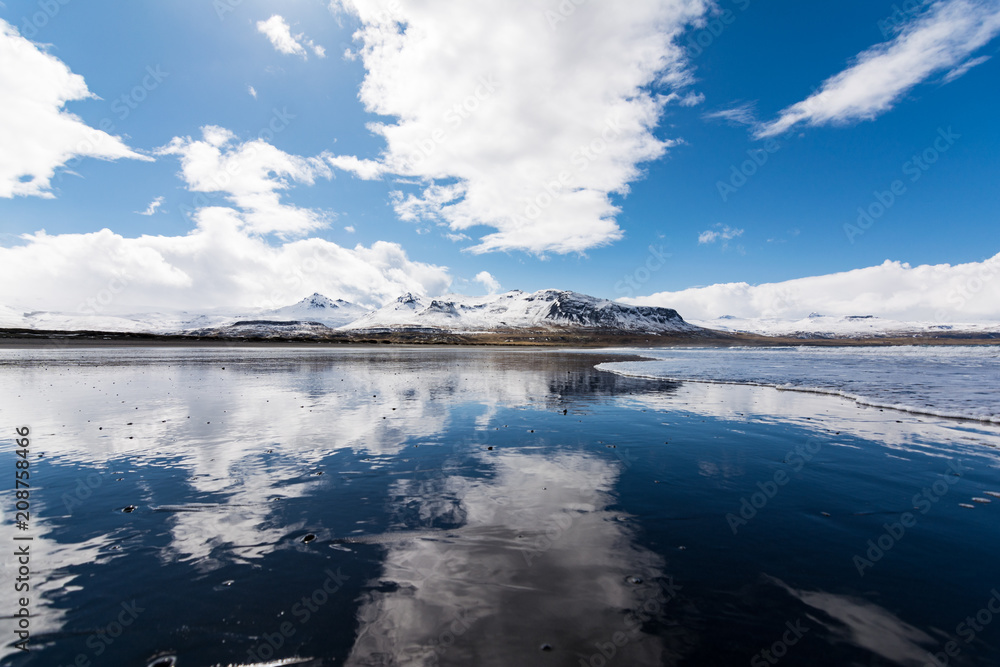 Reflection of sky and volcanic mountains in Snæfellsnes peninsula