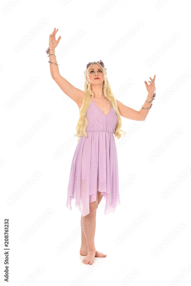 full length portrait of pretty blonde girl wearing purple fairy dress. standing pose, isolated on white studio background. full length portrait of pretty blonde girl wearing purple fairy dress. standing pose, isolated on white studio background.