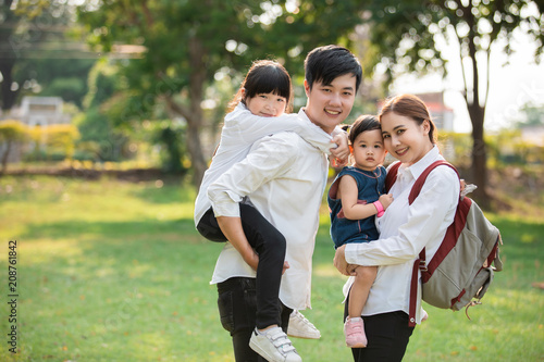 Asian family portrait with happy people smiling at the park ,Lifestyle and Holiday Concept. © lifepic