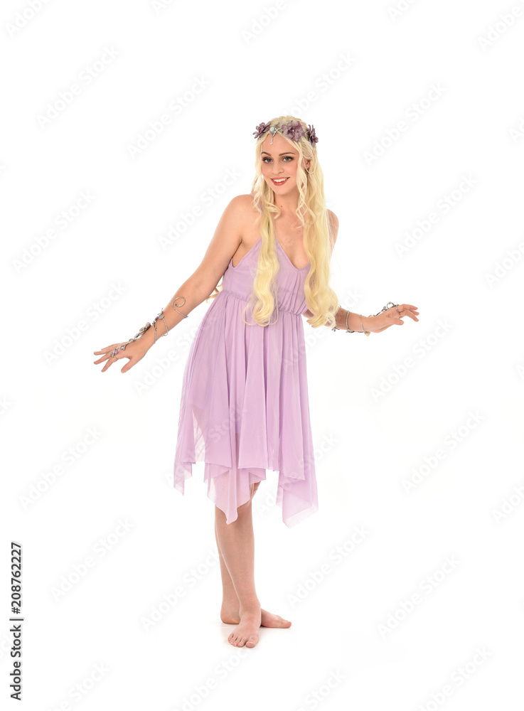 full length portrait of pretty blonde girl wearing purple fairy dress. standing pose, isolated on white studio background. full length portrait of pretty blonde girl wearing purple fairy dress. standing pose, isolated on white studio background.