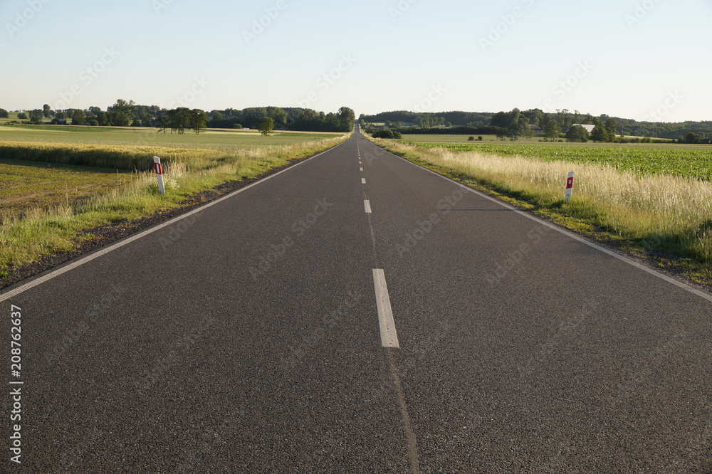 Local asphalt road running among farmland.