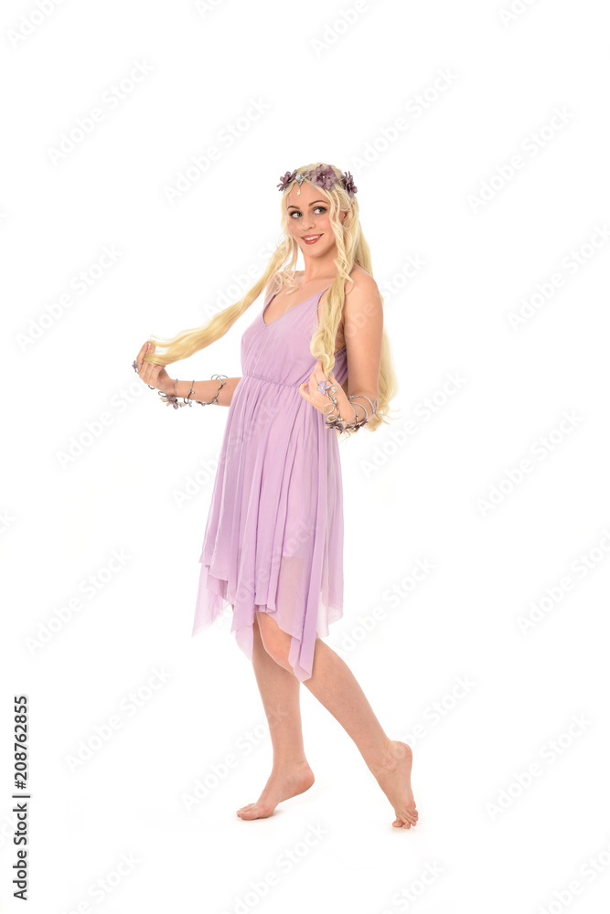 full length portrait of pretty blonde girl wearing purple fairy dress. standing pose, isolated on white studio background. full length portrait of pretty blonde girl wearing purple fairy dress. standing pose, isolated on white studio background.