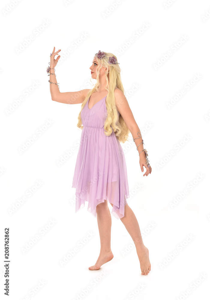 full length portrait of pretty blonde girl wearing purple fairy dress. standing pose, isolated on white studio background. full length portrait of pretty blonde girl wearing purple fairy dress. standing pose, isolated on white studio background.