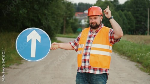 Construction worker showing Turning traffic signs up photo