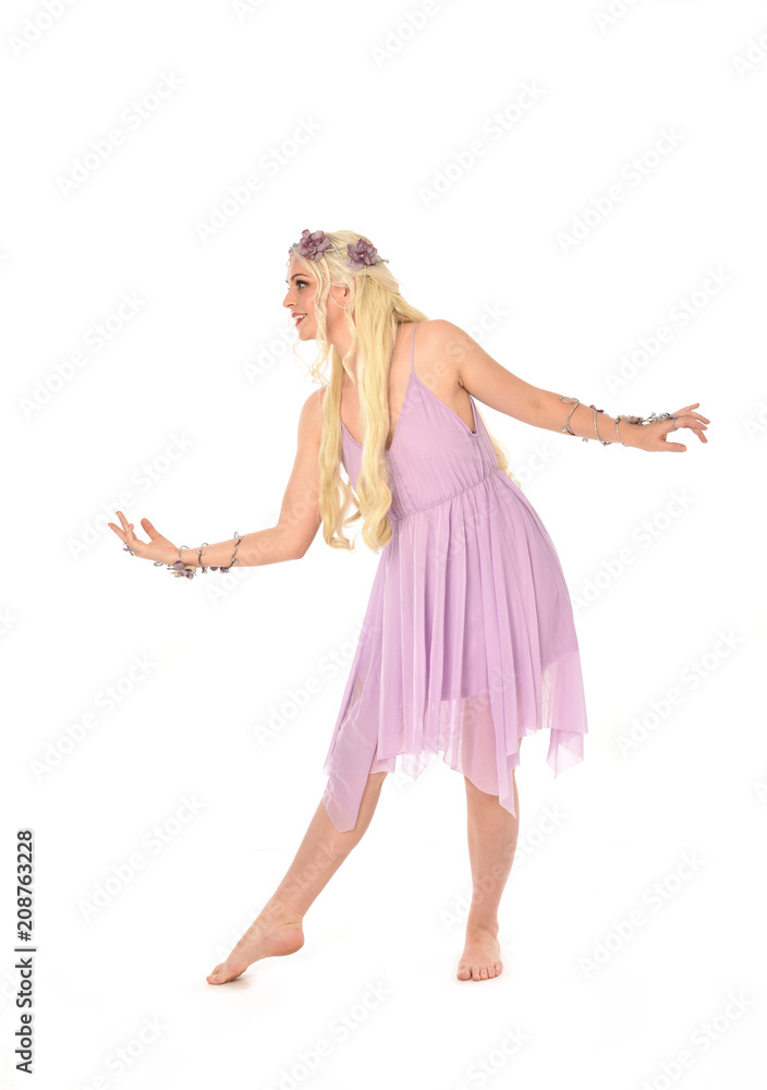 full length portrait of pretty blonde girl wearing purple fairy dress. standing pose, isolated on white studio background. full length portrait of pretty blonde girl wearing purple fairy dress. standing pose, isolated on white studio background.