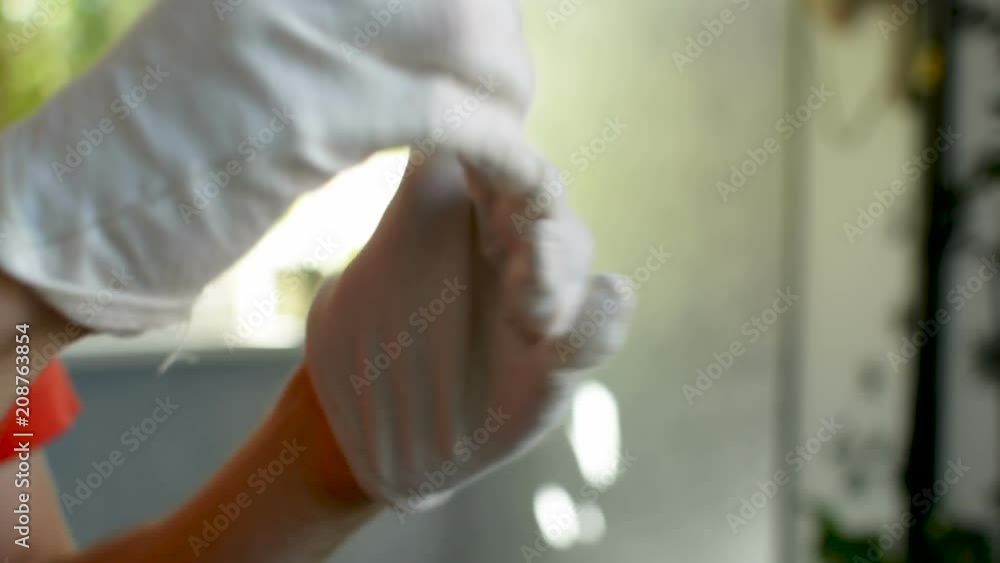 Slowly taking off cloth gloves after healthcare procedure on the skin closeup Slowly taking off cloth gloves after healthcare procedure on the skin closeup