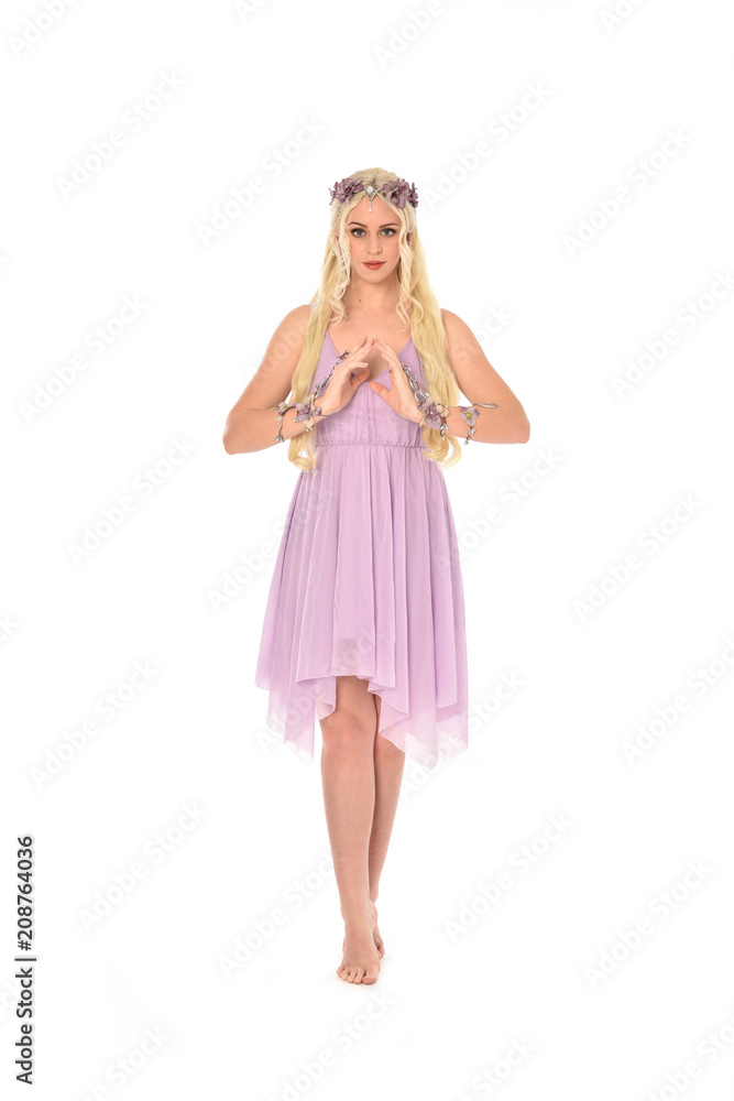 full length portrait of pretty blonde girl wearing purple fairy dress. standing pose, isolated on white studio background. full length portrait of pretty blonde girl wearing purple fairy dress. standing pose, isolated on white studio background.