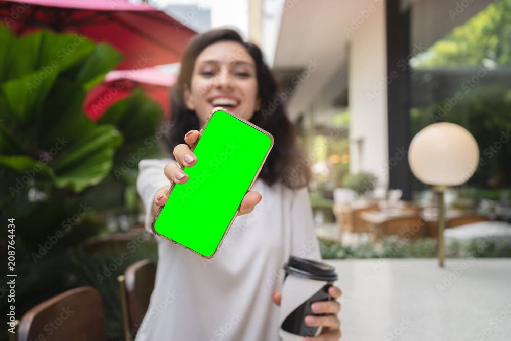 young woman showing modern gold smartphone with green screen for replacement