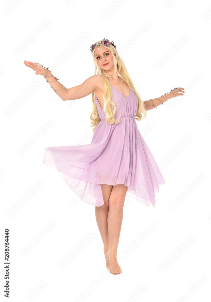 full length portrait of pretty blonde girl wearing purple fairy dress. standing pose, isolated on white studio background. full length portrait of pretty blonde girl wearing purple fairy dress. standing pose, isolated on white studio background.