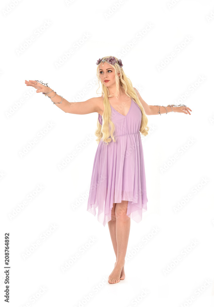 full length portrait of pretty blonde girl wearing purple fairy dress. standing pose, isolated on white studio background.