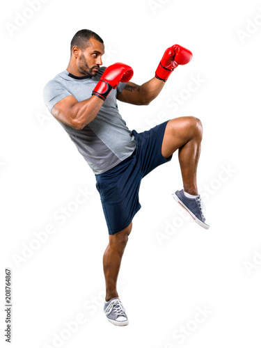 Strong sport man with boxing gloves fighting on isolated white background