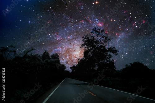 Galaxy on night sky over country road