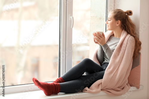 Young woman drinking tea ne...