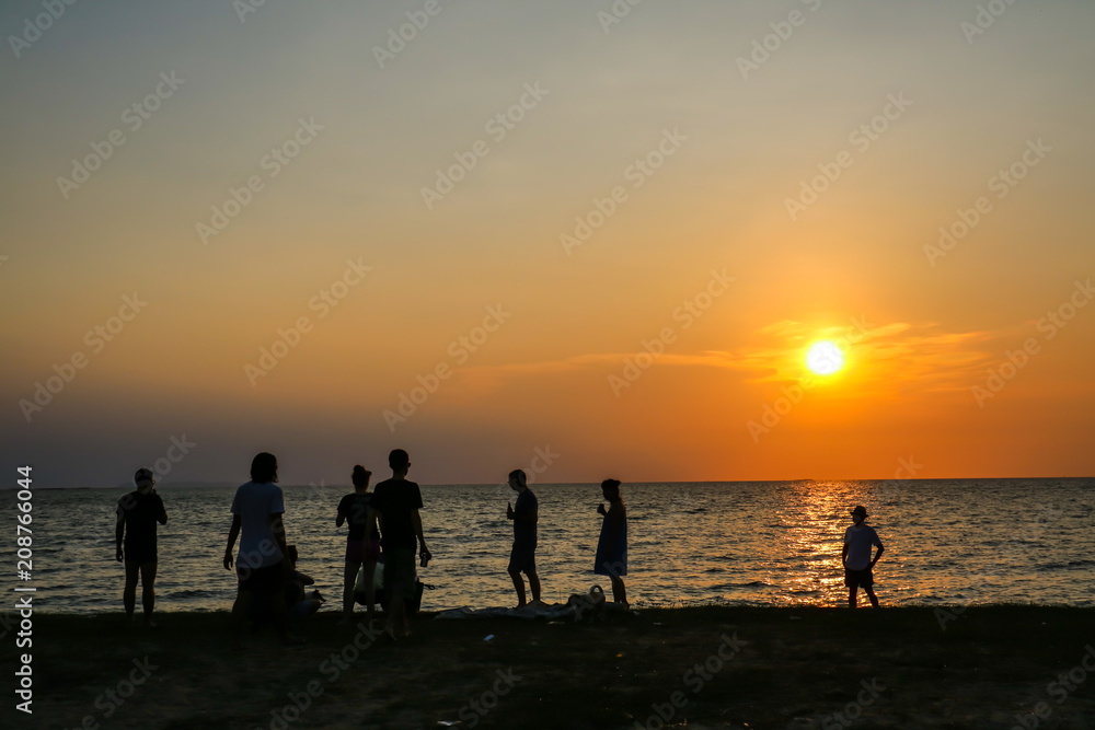 silhouette family and soft drink meeting on beach sunset
