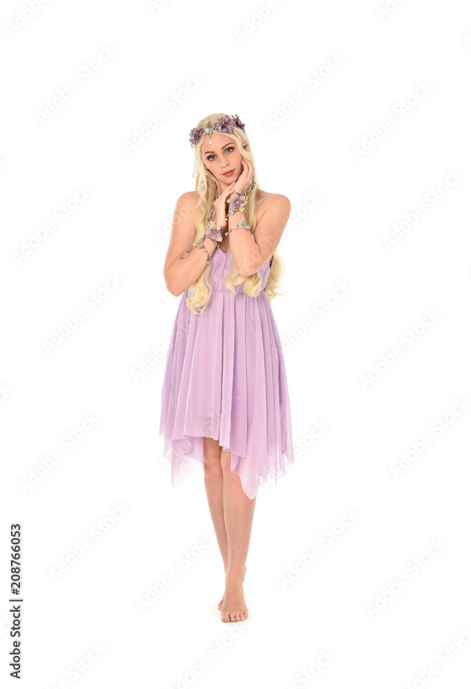 full length portrait of pretty blonde girl wearing purple fairy dress. standing pose, isolated on white studio background.