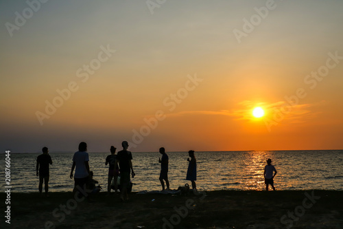 silhouette family and soft drink meeting on beach sunset