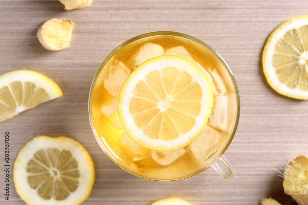 Glass cup of delicious tea with ice and lemon on table Glass cup of delicious tea with ice and lemon on table