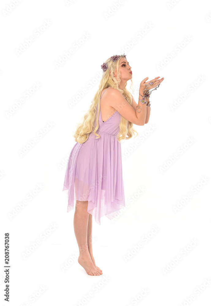 full length portrait of pretty blonde girl wearing purple fairy dress. standing pose, isolated on white studio background. full length portrait of pretty blonde girl wearing purple fairy dress. standing pose, isolated on white studio background.